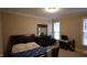 A cozy bedroom featuring plush carpeting, a dresser with mirror, and a comfy bed at 901 Hollymont Dr, Holly Springs, NC 27540