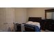 A cozy bedroom with a plush bed, dresser with mirror, and a closet with double doors at 901 Hollymont Dr, Holly Springs, NC 27540