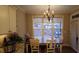 Sunny dining area features a wooden table with seating for four people and large windows at 901 Hollymont Dr, Holly Springs, NC 27540