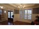 Formal dining room featuring wainscoting, a large window, chandelier and hardwood floors at 901 Hollymont Dr, Holly Springs, NC 27540
