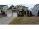 Beautiful two-story home with stone accents, a covered porch, and a well-manicured lawn at 901 Hollymont Dr, Holly Springs, NC 27540