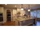 Open kitchen features a large center island, stainless appliances, white cabinets and granite countertops at 901 Hollymont Dr, Holly Springs, NC 27540