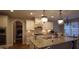 This bright kitchen features white cabinets, granite countertops, an island and stainless steel appliances at 901 Hollymont Dr, Holly Springs, NC 27540