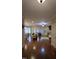 Bright open-concept living room features hardwood floors and lots of natural light from large windows at 901 Hollymont Dr, Holly Springs, NC 27540