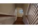 A staircase with wooden steps and black metal railing, leading to the upper level of the home at 901 Hollymont Dr, Holly Springs, NC 27540