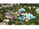 Aerial view of community pools, splash pad, and clubhouse surrounded by mature trees at 91 Cliffdale Rd, Chapel Hill, NC 27516