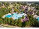 Aerial view of community pool with water slide, sun umbrellas, and lush landscaping at 91 Cliffdale Rd, Chapel Hill, NC 27516