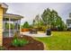 Serene backyard showcasing a patio with seating, a grill, and a play area surrounded by greenery at 91 Cliffdale Rd, Chapel Hill, NC 27516