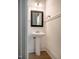 Bathroom with a pedestal sink, wainscoting, and decorative mirror at 91 Cliffdale Rd, Chapel Hill, NC 27516