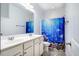 Clean bathroom with double sink vanity and cheerful ocean themed shower curtain at 91 Cliffdale Rd, Chapel Hill, NC 27516