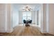 Formal dining room featuring hardwood floors, modern lighting, and stylish blue dining chairs at 91 Cliffdale Rd, Chapel Hill, NC 27516