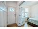 Elegant entryway with hardwood floors and wainscoting leads to a bedroom with a bed at 91 Cliffdale Rd, Chapel Hill, NC 27516