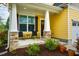 Inviting front porch with stone-clad columns and comfortable seating perfect for relaxing at 91 Cliffdale Rd, Chapel Hill, NC 27516