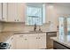 Bright kitchen featuring white cabinets, stainless steel appliances, granite countertops, and subway tile backsplash at 91 Cliffdale Rd, Chapel Hill, NC 27516