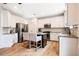Modern kitchen with stainless steel appliances, granite countertops, and a center island with seating at 91 Cliffdale Rd, Chapel Hill, NC 27516