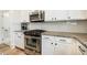 Up close shot of a kitchen featuring stainless steel appliances and granite countertops at 91 Cliffdale Rd, Chapel Hill, NC 27516