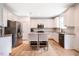 Bright kitchen features white cabinets, stainless steel appliances, granite countertops, and wood floors at 91 Cliffdale Rd, Chapel Hill, NC 27516