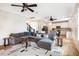 Spacious living room with grey sofa, ceiling fans, and open concept kitchen at 91 Cliffdale Rd, Chapel Hill, NC 27516