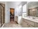 Bright main bathroom with double sinks, shower, and walk-in closet offers plenty of space and functionality at 91 Cliffdale Rd, Chapel Hill, NC 27516