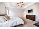 Another spacious main bedroom angle featuring a tray ceiling, TV, and a dresser at 91 Cliffdale Rd, Chapel Hill, NC 27516