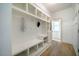 Mudroom featuring storage cabinets, a bench, and white trim at 91 Cliffdale Rd, Chapel Hill, NC 27516