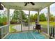 Cozy screened porch with outdoor furniture and a view of the landscaped backyard and playground at 91 Cliffdale Rd, Chapel Hill, NC 27516