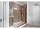 Modern bathroom shower with tiled walls and glass door, providing a clean and stylish bathing experience at 91 Cliffdale Rd, Chapel Hill, NC 27516