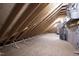 Unfinished attic space with exposed beams, perfect for storage or renovation at 928 Lily Claire Ln, Fuquay Varina, NC 27526