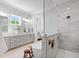 Bright bathroom with a soaking tub, glass-enclosed shower, and double vanity with granite countertops at 928 Lily Claire Ln, Fuquay Varina, NC 27526