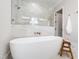 Bright bathroom featuring a soaking tub with glass-enclosed shower and updated fixtures at 928 Lily Claire Ln, Fuquay Varina, NC 27526
