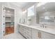 Bathroom featuring a double vanity with granite countertops, with mirrors and updated fixtures at 928 Lily Claire Ln, Fuquay Varina, NC 27526