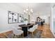 Chic dining room with modern chandelier and art, connects to kitchen at 928 Lily Claire Ln, Fuquay Varina, NC 27526