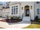 Close up of a home's entrance, showcasing the front door, landscaping, and architectural details, including a window at 928 Lily Claire Ln, Fuquay Varina, NC 27526