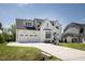 Beautiful two-story home with a three-car garage, driveway, and manicured front lawn at 928 Lily Claire Ln, Fuquay Varina, NC 27526