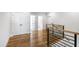 Bright hallway features hardwood floors and white doors leading to additional rooms at 928 Lily Claire Ln, Fuquay Varina, NC 27526