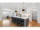 Bright open kitchen features a large island with seating and modern pendant lighting at 928 Lily Claire Ln, Fuquay Varina, NC 27526