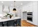 Modern kitchen boasts stainless steel appliances, quartz countertops, and ample storage at 928 Lily Claire Ln, Fuquay Varina, NC 27526