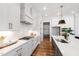 Well-lit kitchen with stylish white cabinetry, brass hardware, and modern appliances at 928 Lily Claire Ln, Fuquay Varina, NC 27526