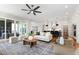 Open-concept living room with hardwood floors, a sleek kitchen, comfortable seating, and sliding doors to the patio at 928 Lily Claire Ln, Fuquay Varina, NC 27526