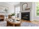 Cozy living room with hardwood floors, a modern fireplace, stylish decor, and comfortable seating with an inviting atmosphere at 928 Lily Claire Ln, Fuquay Varina, NC 27526