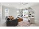 Elegant living room with custom built-ins, a ceiling fan, and lots of natural light at 928 Lily Claire Ln, Fuquay Varina, NC 27526