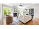 Bright and airy living room with a fireplace, hardwood floors, modern furnishings, and large windows with natural light at 928 Lily Claire Ln, Fuquay Varina, NC 27526