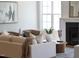 Elegant living room with hardwood floors, a modern fireplace, comfortable seating, and decorative accents for style at 928 Lily Claire Ln, Fuquay Varina, NC 27526
