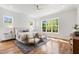 Bright main bedroom with large windows, sitting area, and hardwood floors at 928 Lily Claire Ln, Fuquay Varina, NC 27526