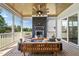 Inviting screened porch with a cozy fireplace and comfortable seating for outdoor relaxation at 928 Lily Claire Ln, Fuquay Varina, NC 27526