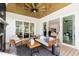 Charming screened porch featuring a fireplace, ceiling fan, and sliding glass doors to the home interior at 928 Lily Claire Ln, Fuquay Varina, NC 27526