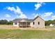 Back exterior of home with a screened-in porch and a well-maintained lawn at 9391 Turkey Way, Middlesex, NC 27557