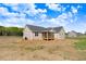 Back exterior of home with a screened-in porch and a spacious backyard at 9391 Turkey Way, Middlesex, NC 27557