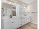 Bathroom with dual vanities, white cabinets, quartz counters, and modern fixtures at 9391 Turkey Way, Middlesex, NC 27557