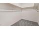 Walk-in closet with wood rods and shelving and carpet flooring for storage at 9391 Turkey Way, Middlesex, NC 27557